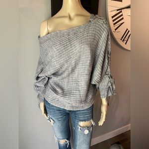 Off the shoulder sweater. Braided sleeve detail.